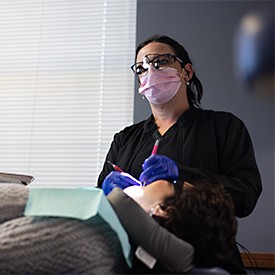 Senior woman pointing to new denture