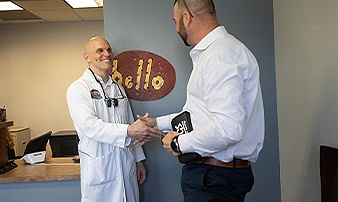 La Plata dentist shaking hands with dental patient