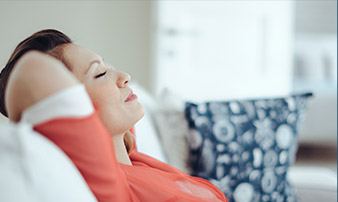 Relaxed woman with hands behind head