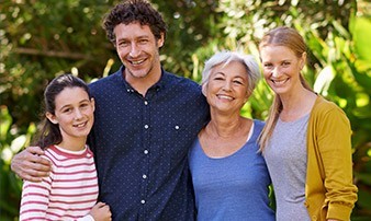 Family smiling together outdoors