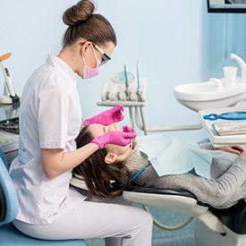 Dental hygienist cleaning a patient’s teeth