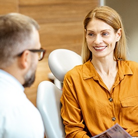 a dentist speaking with a patient