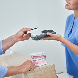 a person checking out after their dental appointment