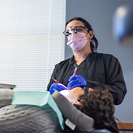 Dentist examining an X-ray of dental implants in La Plata