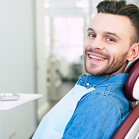 Man smiling while sitting in treatment chair