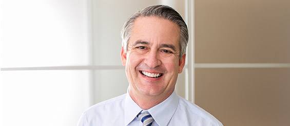 Smiling senior man in business suit