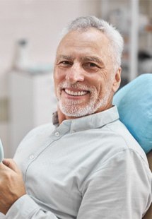 man smiling while visiting dentist in Dahlgren