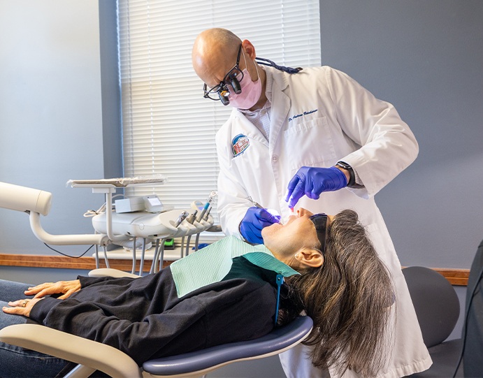 Doctor Betaharon performing a dental exam on a patient