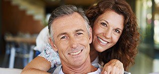 Older man and woman smiling together