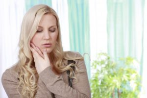 woman with ice pack on face