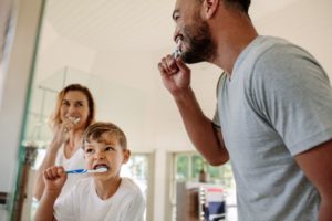 family brushing teeth together