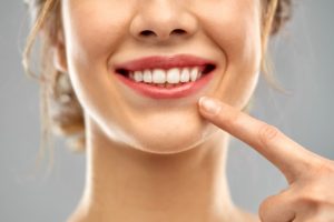 person pointing to their perfect smile