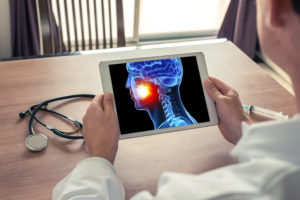 Dentist examining X-ray on tablet