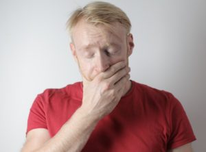 Man in pain from ill-fitting dentures