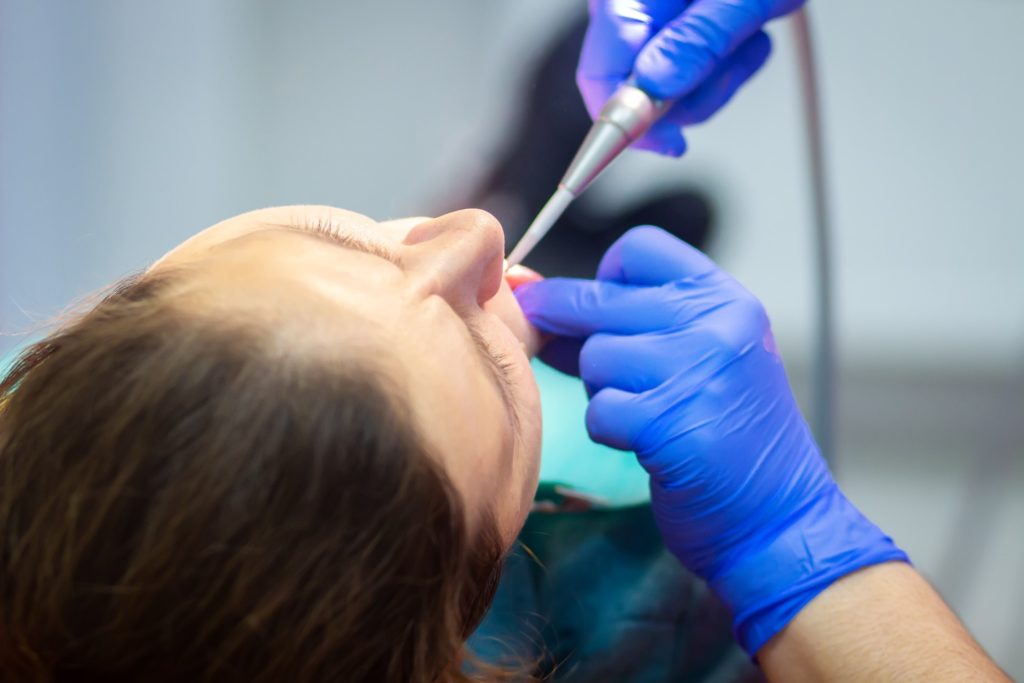 Dentist treating relaxed dental patient