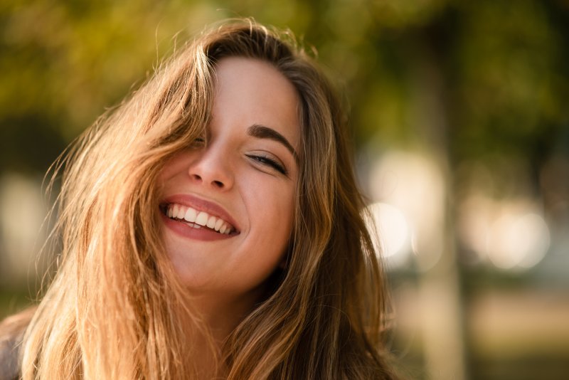 Woman smiling after crown lengthening in La Plata