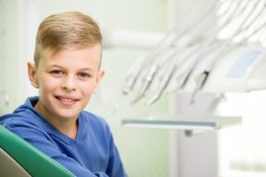 Young boy smiling in dental chair