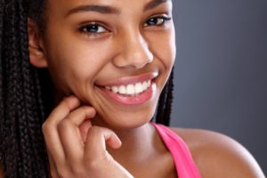 a woman smiling with big and beautiful teeth