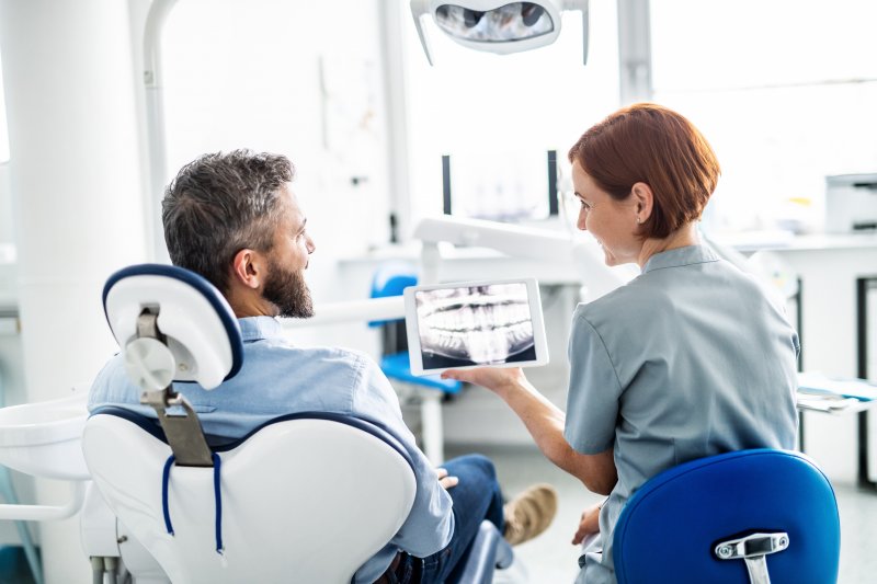 Dentist explaining veneer treatment to patient