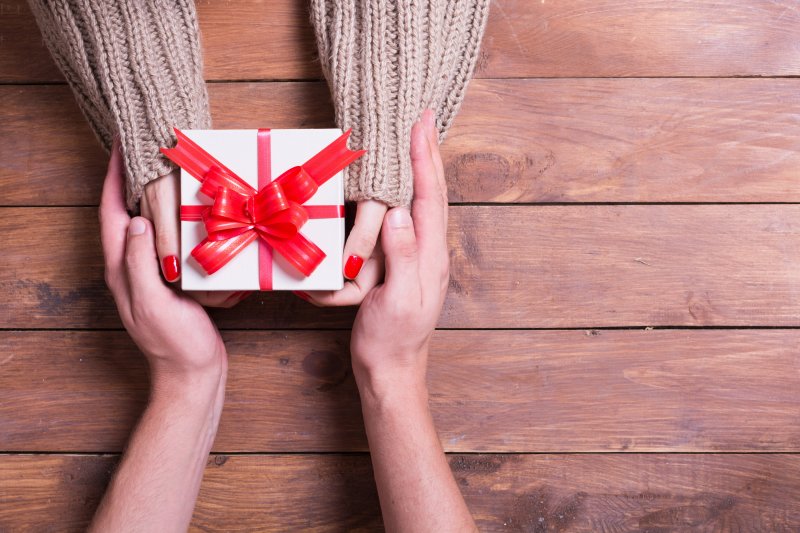 person giving teeth whitening as a gift 