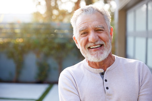 Senior man in white shirt smiling